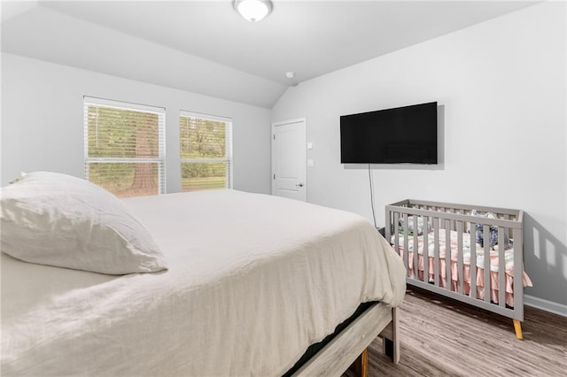 18349 Fox Hollow Loop, Hammond, LA 70401 - bedroom featuring lofted ceiling, wood finished floors, and baseboards