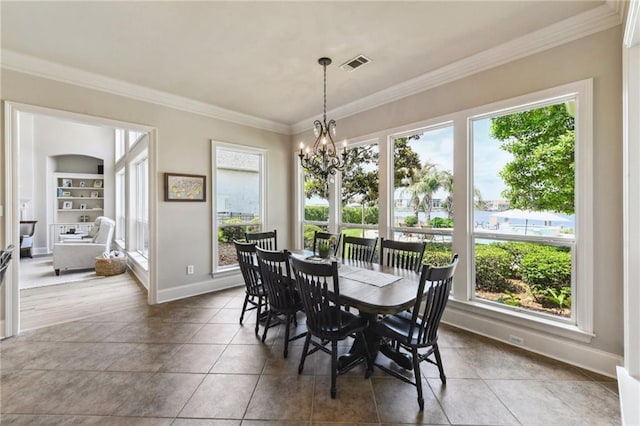 983 Lakeshore Blvd, Slidell, LA 70461 - dining space featuring ornamental molding, a chandelier, baseboards, tile patterned flooring, and plenty of natural light
