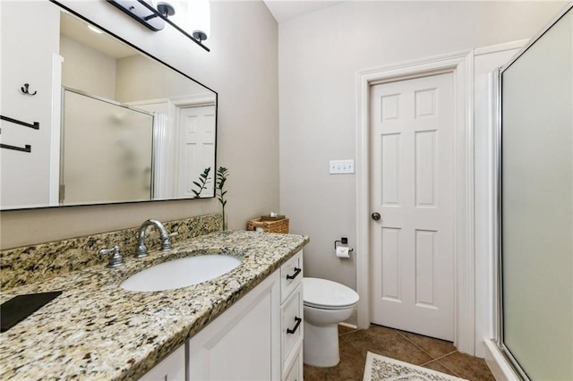 983 Lakeshore Blvd, Slidell, LA 70461 - bathroom featuring vanity, a shower stall, tile patterned flooring, and toilet