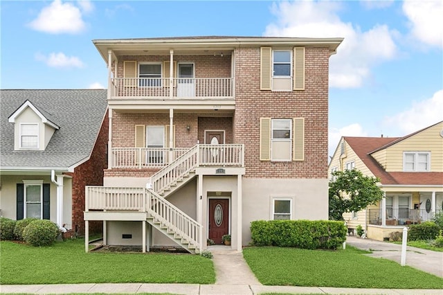 6345 Marshal Foch St, New Orleans, LA 70124 - view of front facade with a balcony, a porch, stairs, brick siding, and a front yard