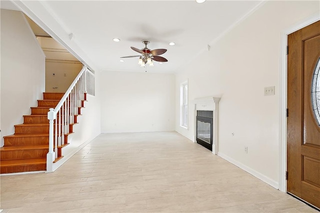 6345 Marshal Foch St, New Orleans, LA 70124 - foyer entrance with ceiling fan, recessed lighting, stairway, a glass covered fireplace, and light wood-type flooring