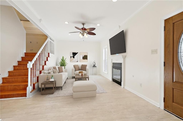 6345 Marshal Foch St, New Orleans, LA 70124 - living room featuring stairway, recessed lighting, ceiling fan, a glass covered fireplace, and light wood-style floors