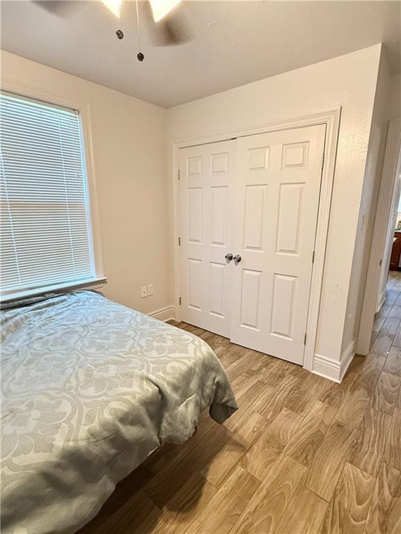 2012 Walkers Ln, Meraux, LA 70075 - bedroom featuring light wood-style floors, baseboards, a closet, and ceiling fan