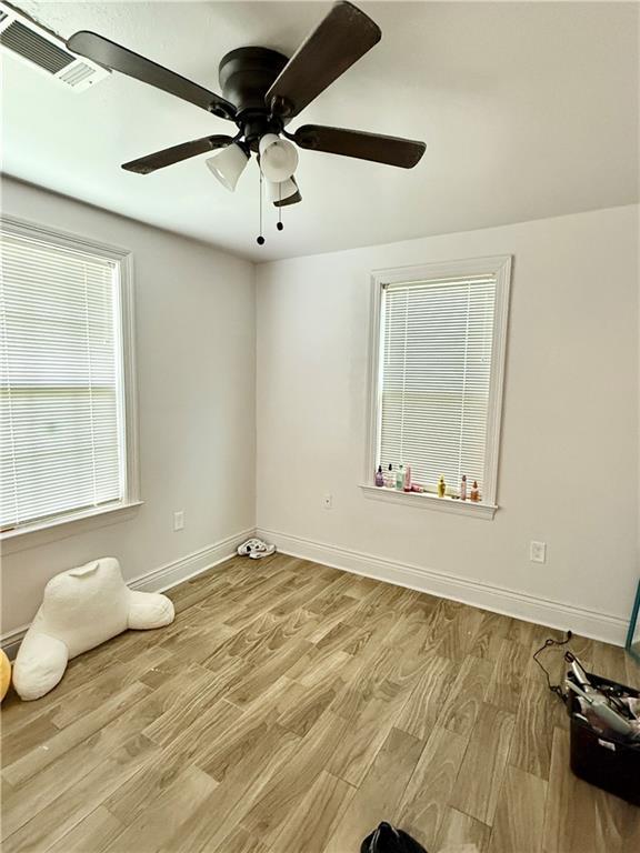 2012 Walkers Ln, Meraux, LA 70075 - spare room featuring a ceiling fan, baseboards, and wood finished floors