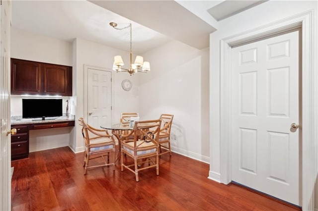 801 Rue Burgundy St Unit 113, Metairie, LA 70005 - dining area with baseboards, dark wood-style floors, and a chandelier