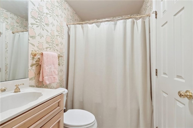 801 Rue Burgundy St Unit 113, Metairie, LA 70005 - bathroom featuring wallpapered walls, vanity, toilet, and curtained shower