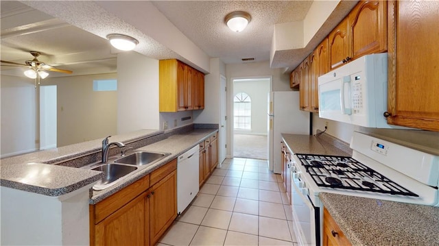 4813 Lake Como Ave, Metairie, LA 70006 - kitchen with white appliances, a sink, ceiling fan, brown cabinets, and a peninsula