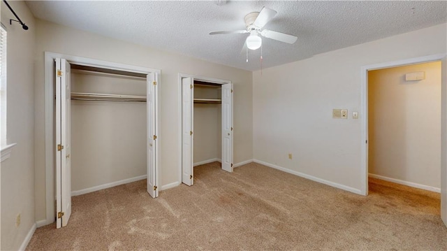 4813 Lake Como Ave, Metairie, LA 70006 - unfurnished bedroom with multiple closets, light carpet, a textured ceiling, a ceiling fan, and baseboards