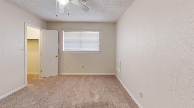 4813 Lake Como Ave, Metairie, LA 70006 - unfurnished bedroom featuring a spacious closet, carpet, a textured ceiling, baseboards, and ceiling fan