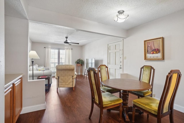 3320 N Arnoult Rd Unit 231, Metairie, LA 70002 - dining space featuring a textured ceiling, baseboards, a ceiling fan, and dark wood-type flooring