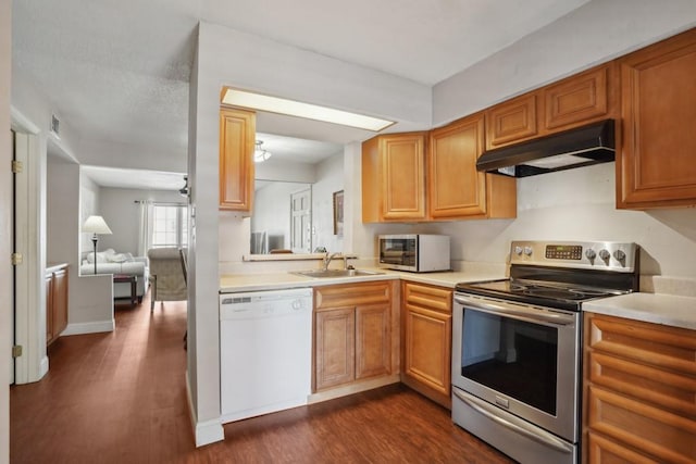 3320 N Arnoult Rd Unit 231, Metairie, LA 70002 - kitchen featuring appliances with stainless steel finishes, a sink, under cabinet range hood, dark wood-style floors, and light countertops