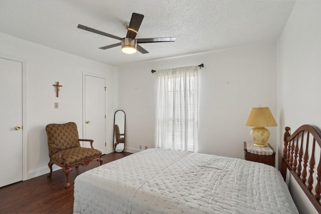 3320 N Arnoult Rd Unit 231, Metairie, LA 70002 - bedroom with dark wood-style flooring, a ceiling fan, baseboards, and a textured ceiling