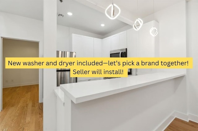822 N Rampart St Unit 203, New Orleans, LA 70116 - kitchen with stainless steel microwave, light wood-type flooring, decorative light fixtures, baseboards, and recessed lighting