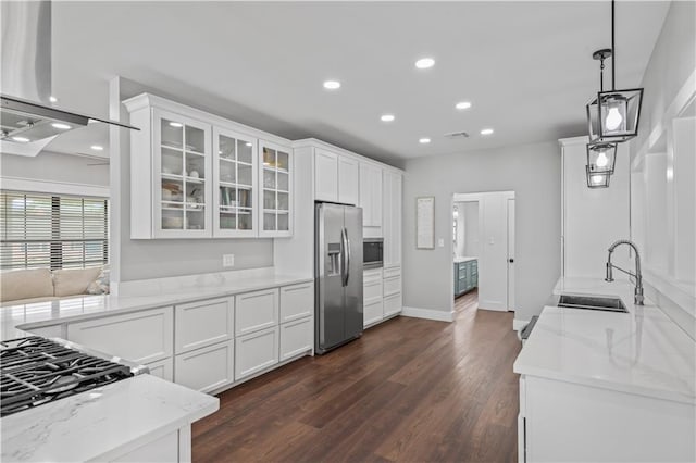 7599 Park Ave, Houma, LA 70364 - kitchen with stainless steel appliances, a sink, recessed lighting, white cabinetry, and light stone countertops
