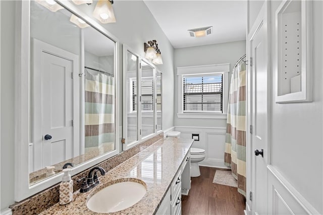 7599 Park Ave, Houma, LA 70364 - full bathroom with vanity, toilet, wood finished floors, and a shower with shower curtain