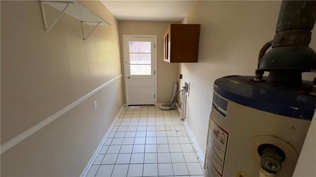 2008 Bluebird St, Slidell, LA 70460 - laundry room featuring light tile patterned flooring, baseboards, and water heater