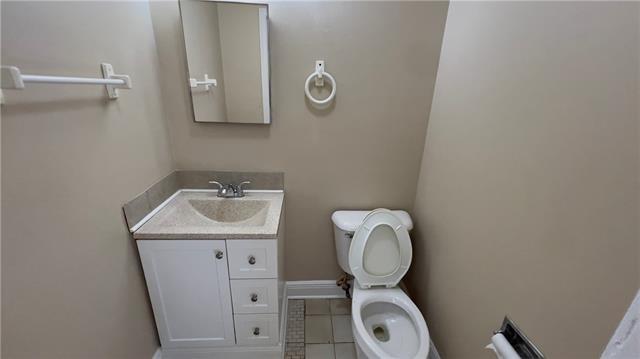 2008 Bluebird St, Slidell, LA 70460 - half bath featuring toilet, tile patterned flooring, vanity, and baseboards