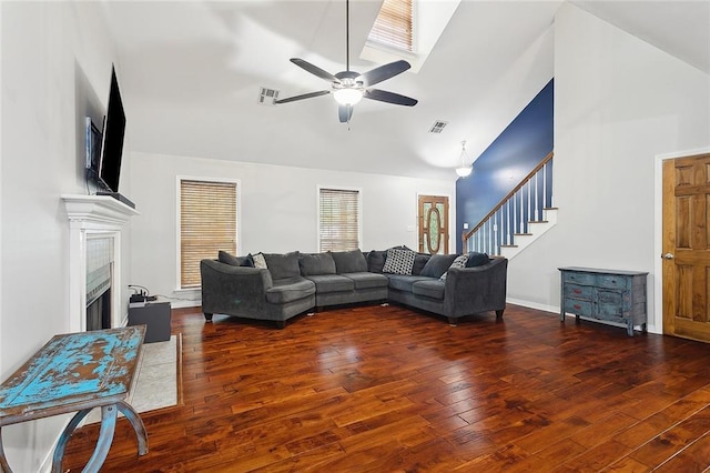 19196 Wildoak Ln, Ponchatoula, LA 70454 - living room with stairway, a fireplace, a ceiling fan, wood finished floors, and high vaulted ceiling