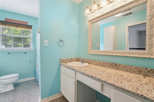 19196 Wildoak Ln, Ponchatoula, LA 70454 - full bathroom with toilet, vanity, baseboards, and tile patterned flooring