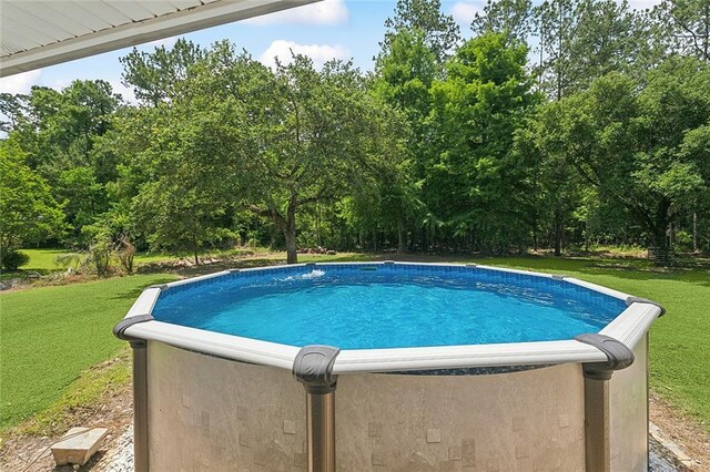 19196 Wildoak Ln, Ponchatoula, LA 70454 - view of pool with a yard and view of wooded area
