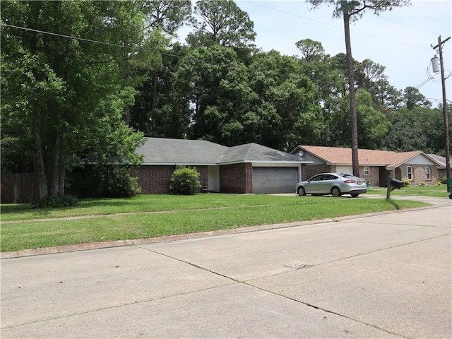 1604 Saint Christopher St, Slidell, LA 70460 - single story home featuring a garage, a front lawn, brick siding, and concrete driveway