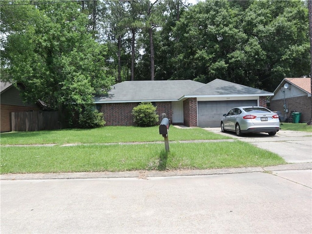 1604 Saint Christopher St, Slidell, LA 70460 - ranch-style house with a garage, driveway, a front lawn, and brick siding