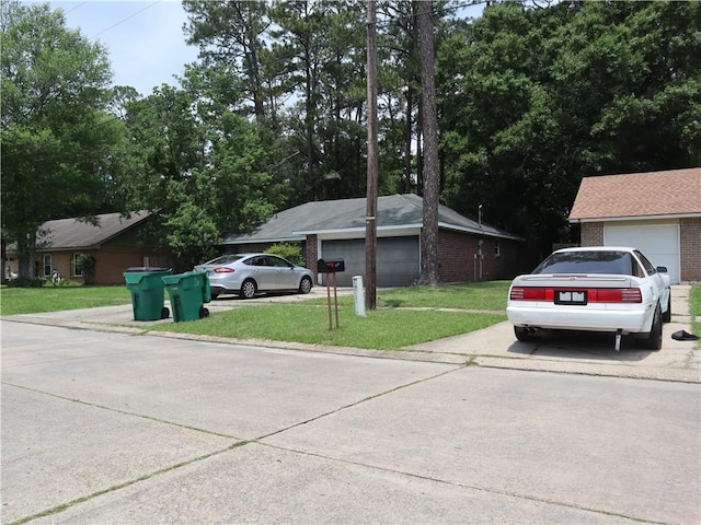 1604 Saint Christopher St, Slidell, LA 70460 - view of front of house featuring a garage, a front lawn, brick siding, and concrete driveway