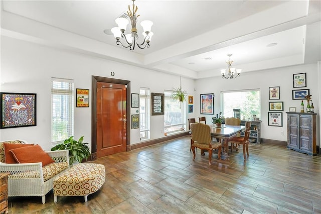 439 S Clark St, New Orleans, LA 70119 - dining room featuring a chandelier, a tray ceiling, and baseboards