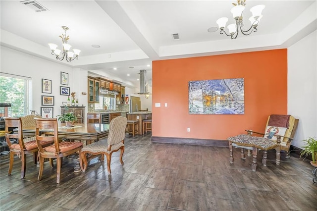 439 S Clark St, New Orleans, LA 70119 - dining area featuring a chandelier, dark wood finished floors, a raised ceiling, beverage cooler, and recessed lighting