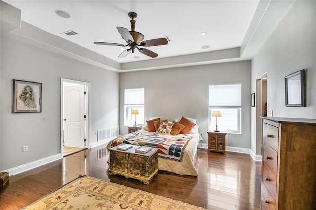 439 S Clark St, New Orleans, LA 70119 - bedroom with dark wood-type flooring, multiple windows, baseboards, and a ceiling fan