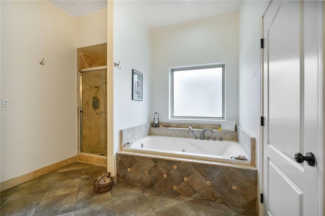 439 S Clark St, New Orleans, LA 70119 - full bath featuring a bath, a stall shower, stone finish flooring, and baseboards