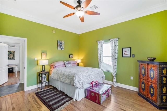 439 S Clark St, New Orleans, LA 70119 - bedroom with ornamental molding, wood finished floors, baseboards, and a ceiling fan