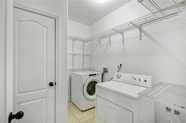 439 S Clark St, New Orleans, LA 70119 - laundry room with washer and clothes dryer and light tile patterned flooring