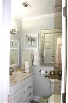 7522 Adventure Ave, New Orleans, LA 70129 - bathroom with crown molding, vanity, and toilet