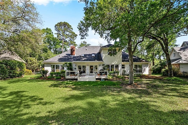 511 Beau Chene Dr, Mandeville, LA 70471 - rear view of house featuring a lawn, a deck, and a chimney