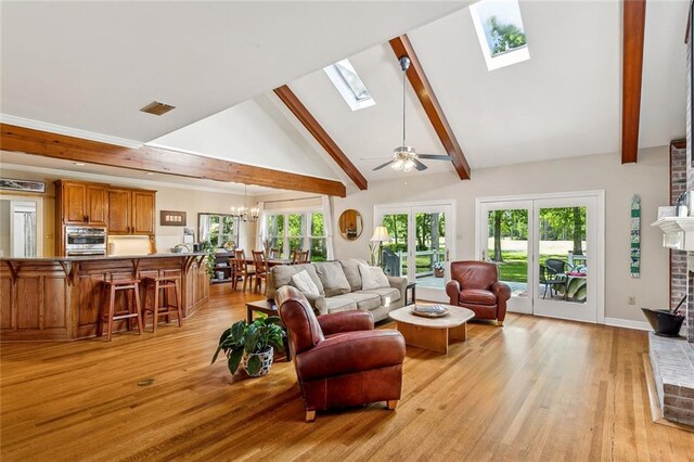 511 Beau Chene Dr, Mandeville, LA 70471 - living area featuring a chandelier, a skylight, light wood-style flooring, beamed ceiling, and high vaulted ceiling