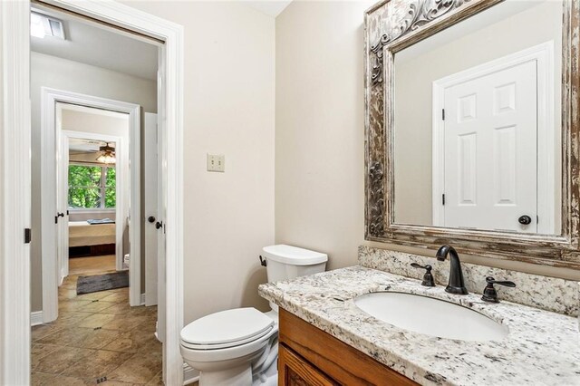 511 Beau Chene Dr, Mandeville, LA 70471 - bathroom featuring vanity, toilet, and baseboards