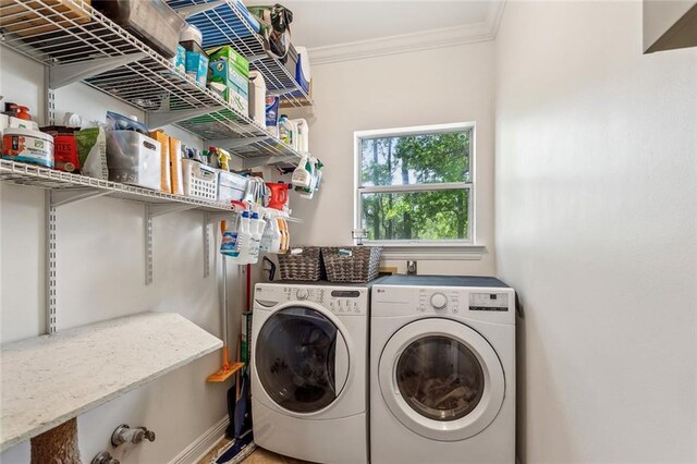 511 Beau Chene Dr, Mandeville, LA 70471 - laundry area featuring washing machine and clothes dryer and ornamental molding