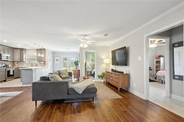 4709 Kawanee Ave, Metairie, LA 70006 - living room with wood finished floors, ceiling fan, ornamental molding, baseboards, and recessed lighting