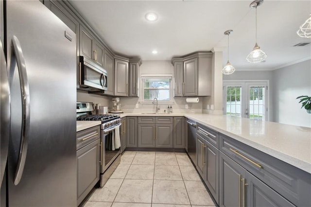 4709 Kawanee Ave, Metairie, LA 70006 - kitchen with appliances with stainless steel finishes, gray cabinets, a sink, crown molding, and light countertops