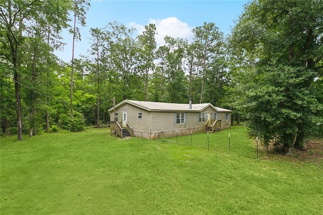 16940 Gunboat Landing Rd, Livingston, LA 70449 - view of green lawn with entry steps and a forest view