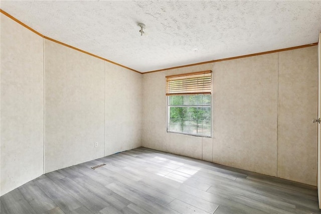 16940 Gunboat Landing Rd, Livingston, LA 70449 - unfurnished room featuring wood finished floors, crown molding, and a textured ceiling
