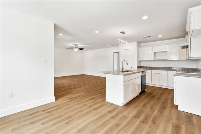 2305 Weyer St, Gretna, LA 70053 - kitchen with a sink, a kitchen island with sink, baseboards, recessed lighting, and white cabinetry