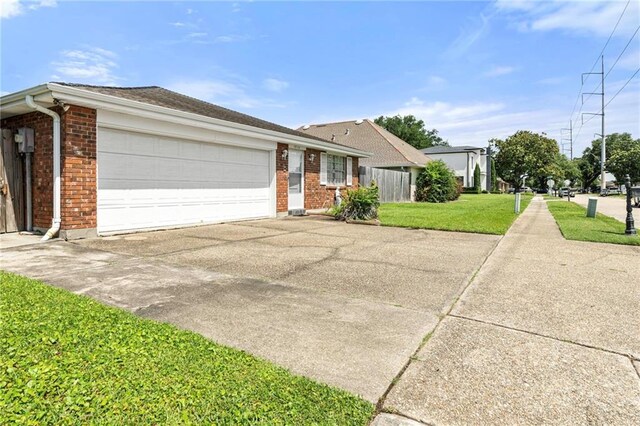 1816 Giuffrias Ave, Metairie, LA 70001 - ranch-style house with brick siding, driveway, an attached garage, and a front yard