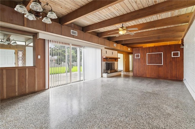 1501 Poinsettia Dr, Metairie, LA 70005 - unfurnished living room featuring wood walls, wood ceiling with exposed beams, speckled floor, and a ceiling fan
