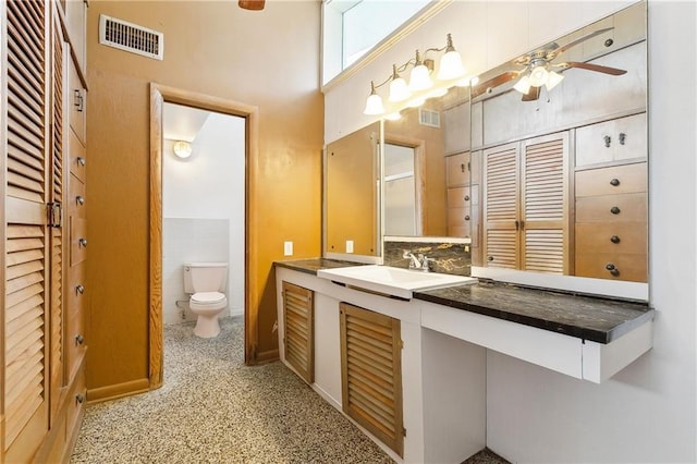 1501 Poinsettia Dr, Metairie, LA 70005 - bathroom featuring a ceiling fan, vanity, toilet, a closet, and a towering ceiling