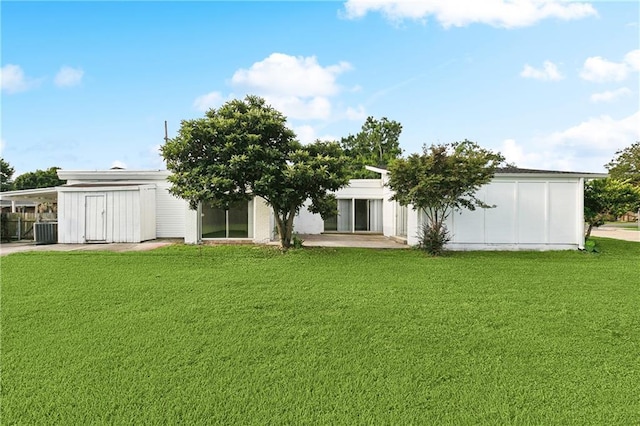 1501 Poinsettia Dr, Metairie, LA 70005 - rear view of property featuring a lawn, central AC unit, and an attached carport