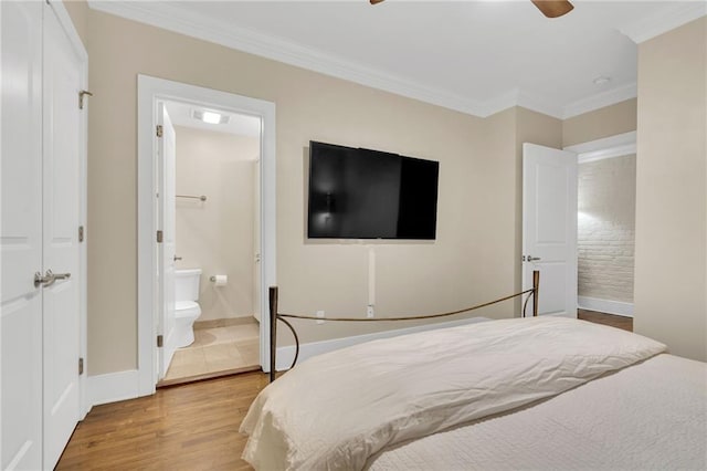 220 Decatur St Unit 302, New Orleans, LA 70130 - bedroom with wood finished floors, ornamental molding, connected bathroom, baseboards, and ceiling fan