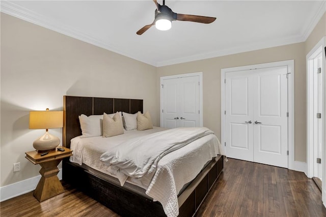220 Decatur St Unit 302, New Orleans, LA 70130 - bedroom featuring dark wood-style floors, ornamental molding, two closets, baseboards, and a ceiling fan