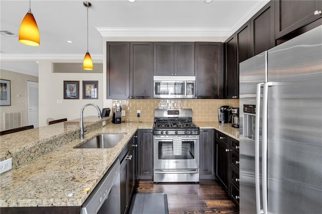 220 Decatur St Unit 304, New Orleans, LA 70130 - kitchen with stainless steel appliances, a sink, a peninsula, crown molding, and dark brown cabinets